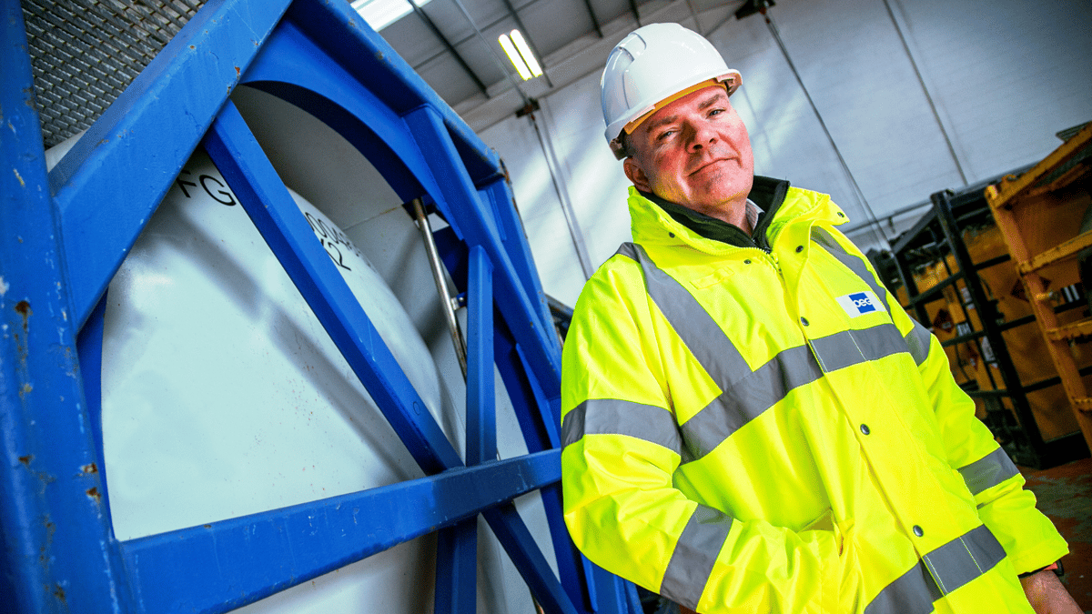 OEG's Managing director of UK stadning in front of a tank container