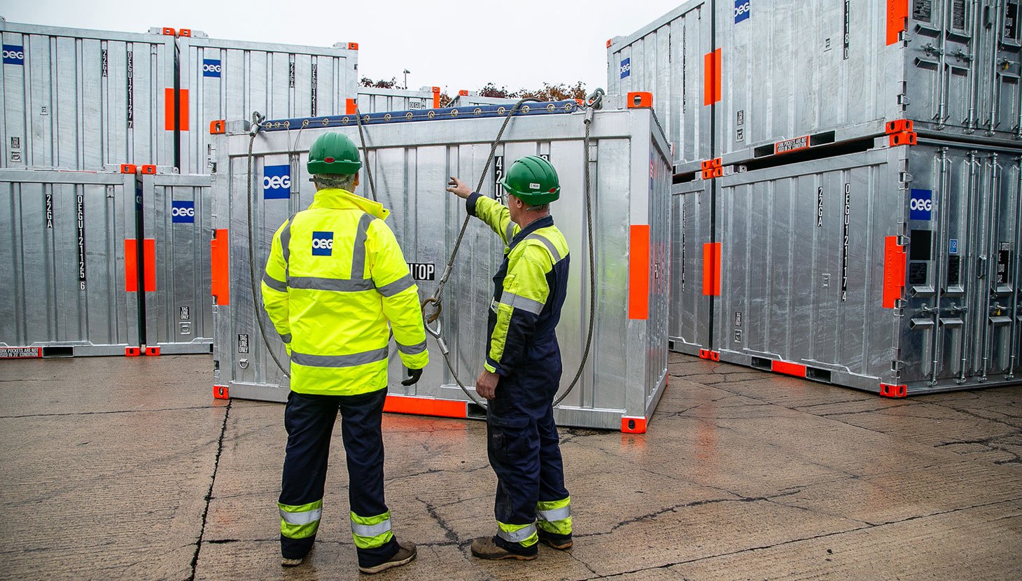 OEG workers in the Bridge of Don yard facing stacked containers