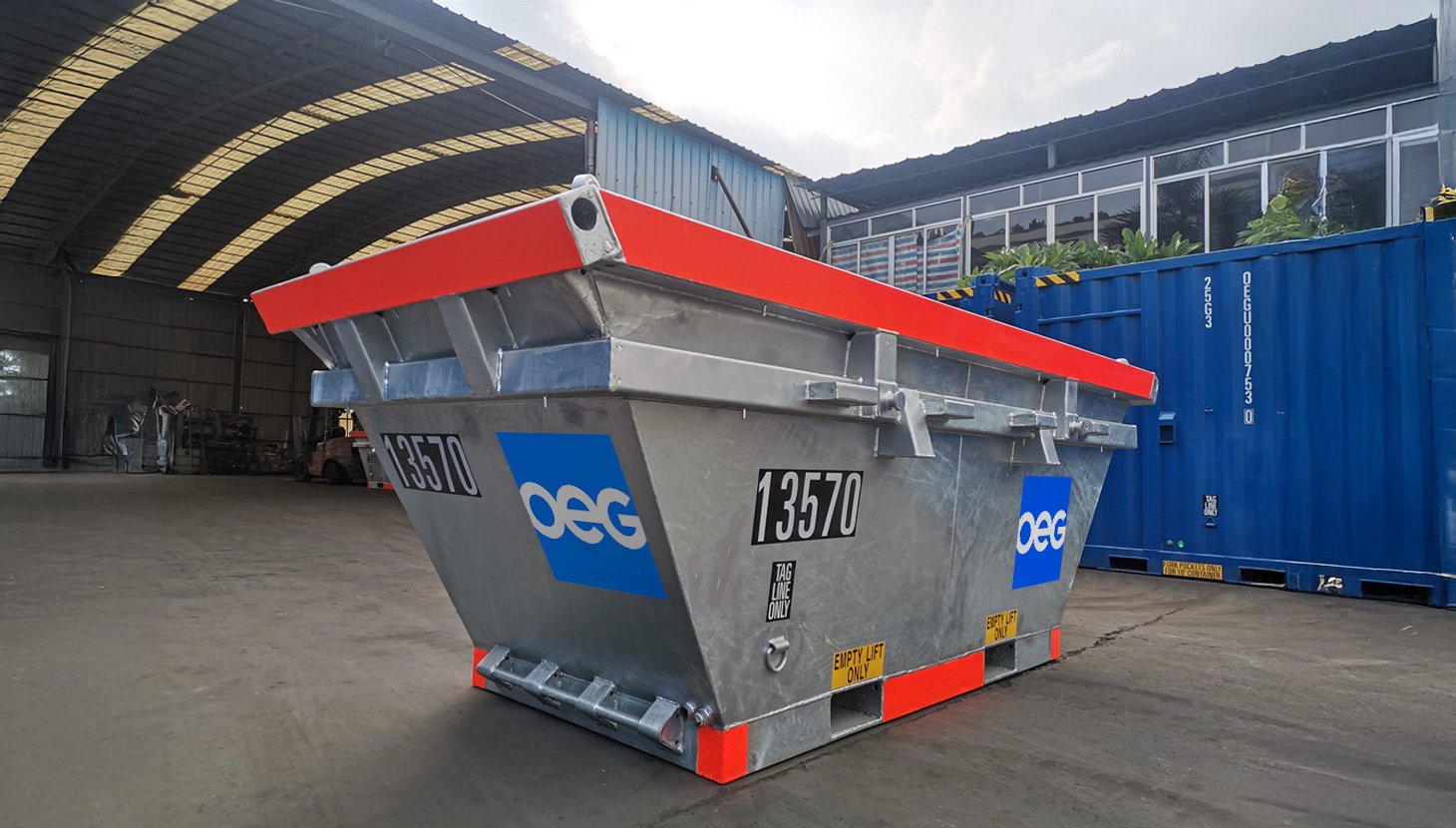 OEG hot dipped galvanised waste skip outside in workshop yard.