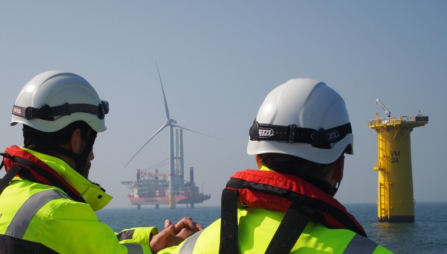 Workers looking out at wind turbine