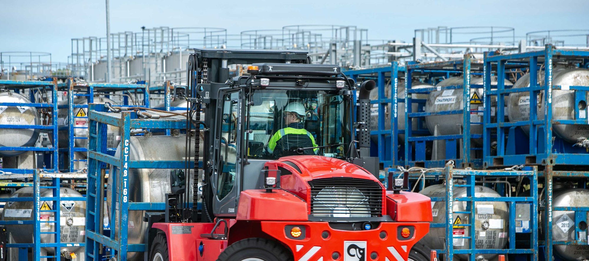 OEG chemical plant with red forklift transporting tanks