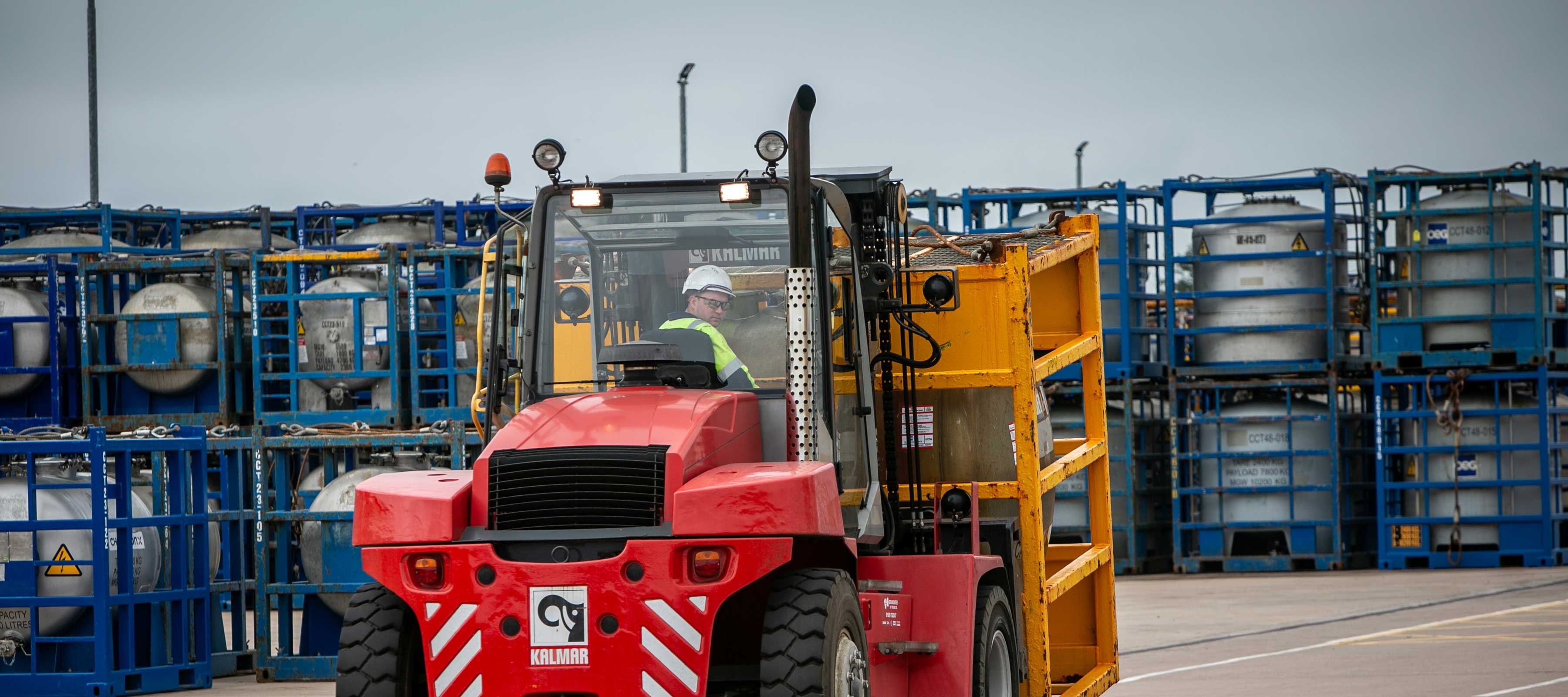 Chemical tanks in yard with forklift in operation