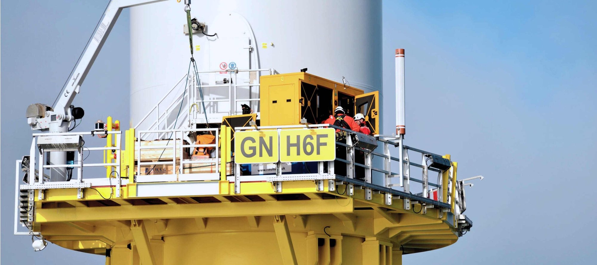 Close up of people working on wind turbine