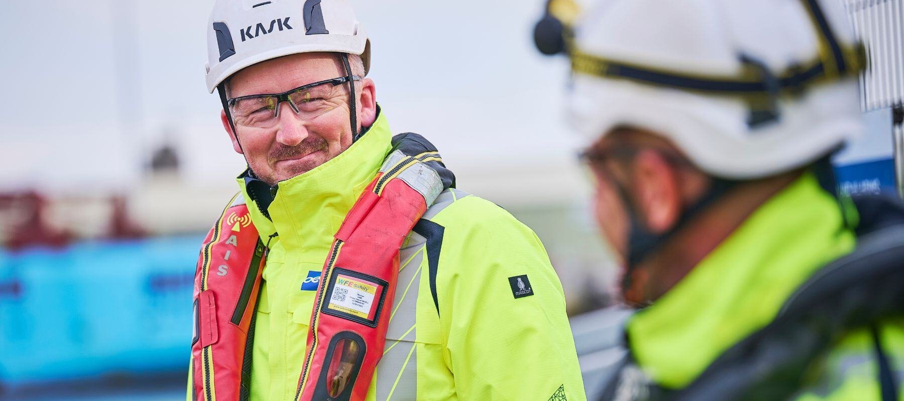 OEG Renewables engineers in full PPE talking to each other.