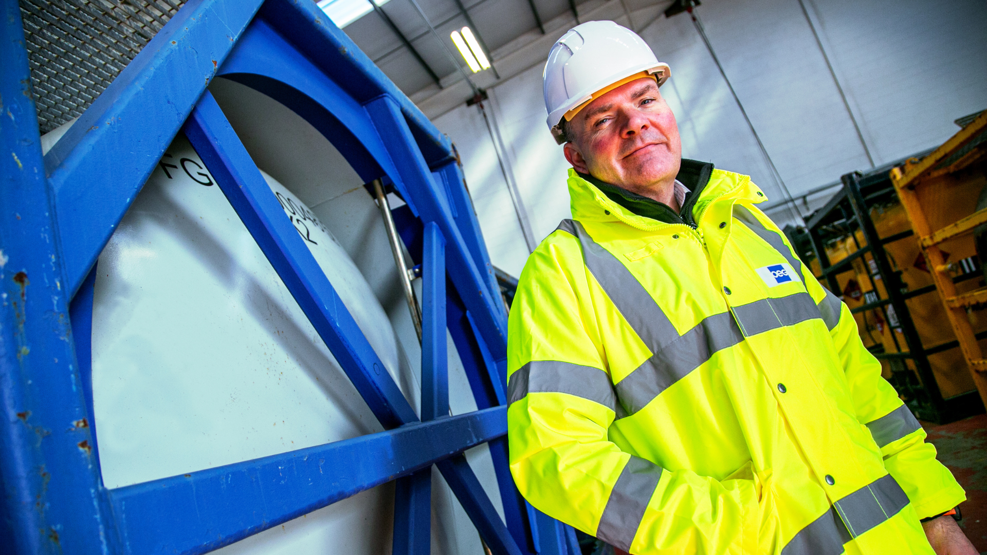 OEG's Managing director of UK stadning in front of a tank container