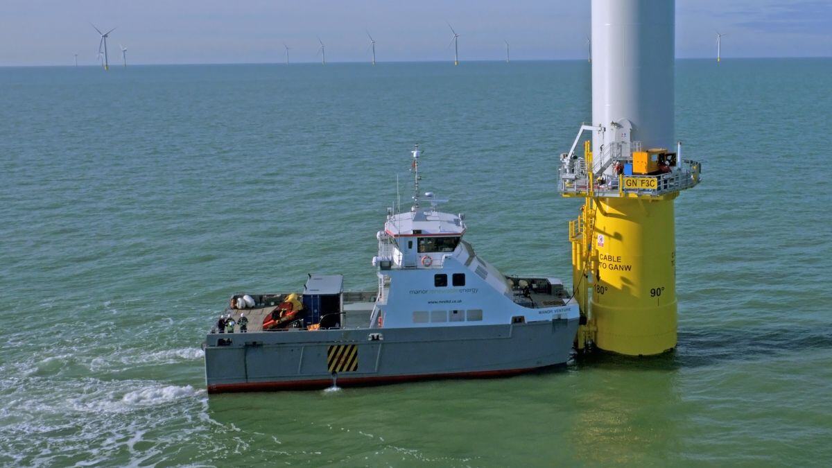 Vessel beside wind turbine at sea