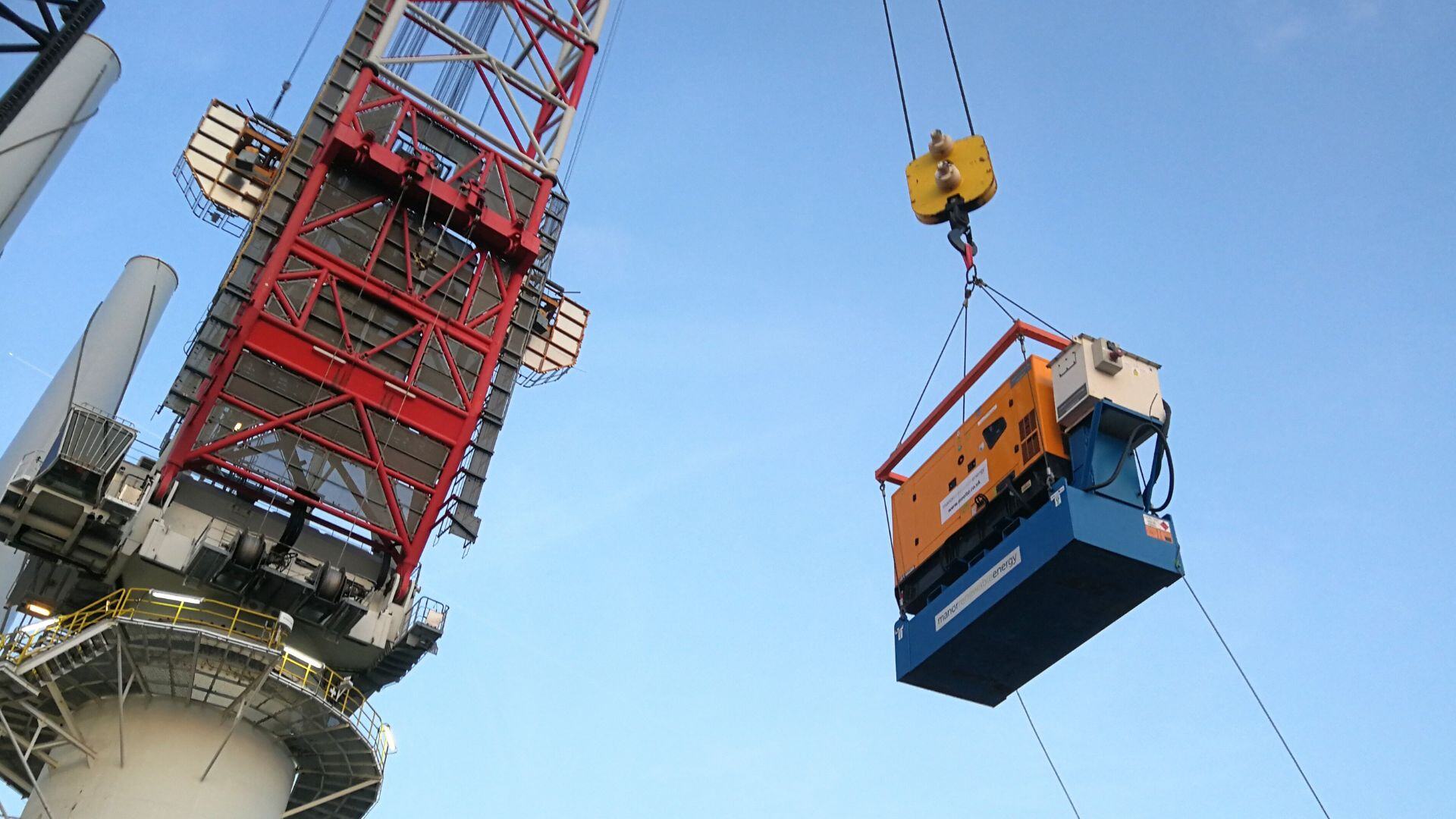 Temporary power unit being lifted by crane