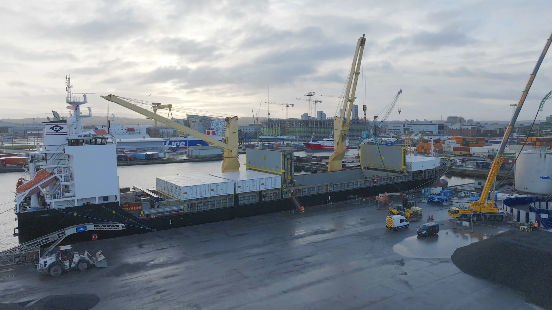 Subsea export cable being transpooled from vessel to storage facility